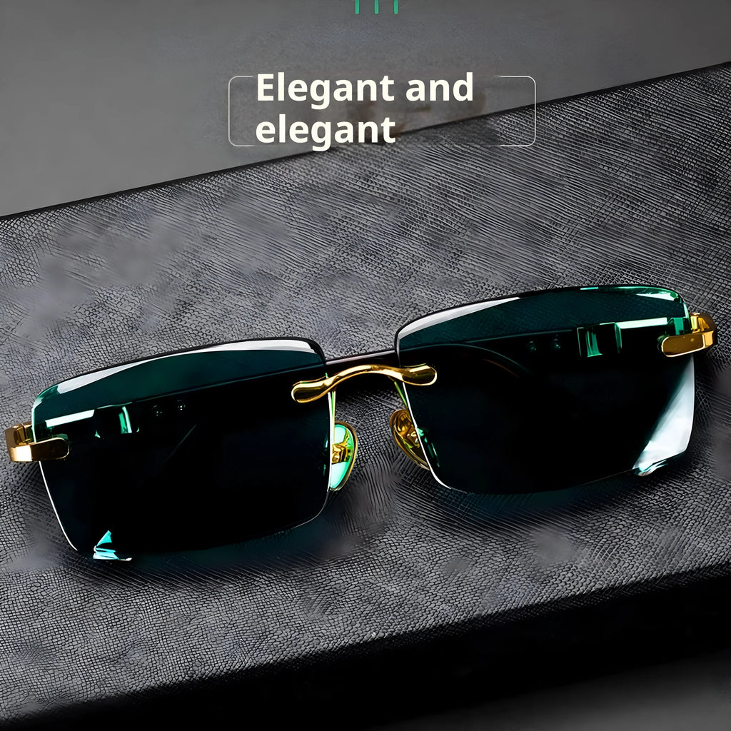 A pair of dark green frameless crystal sunglasses with a hard case and a lens cloth on a plain background.