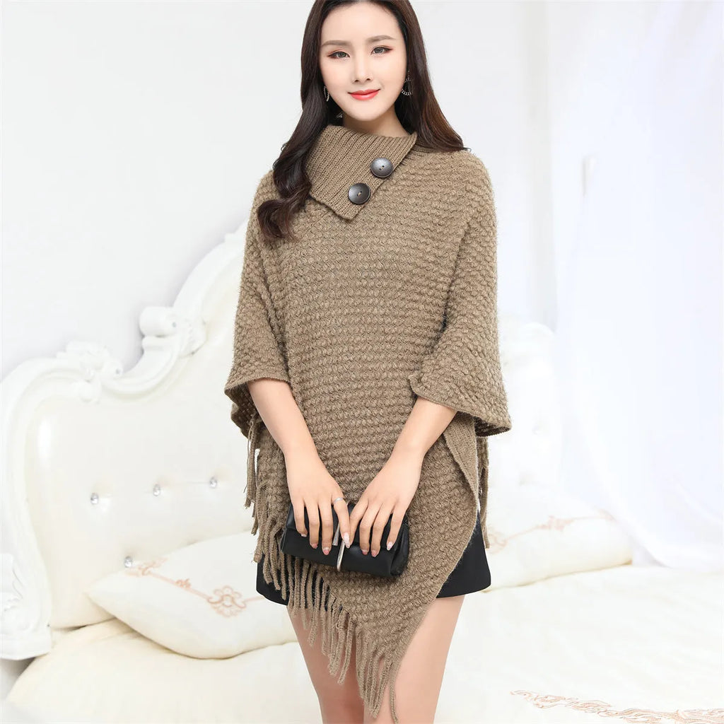 Dotted pattern sleeveless knitted cloak shawl in acrylic fibre, shown in apricot colour.