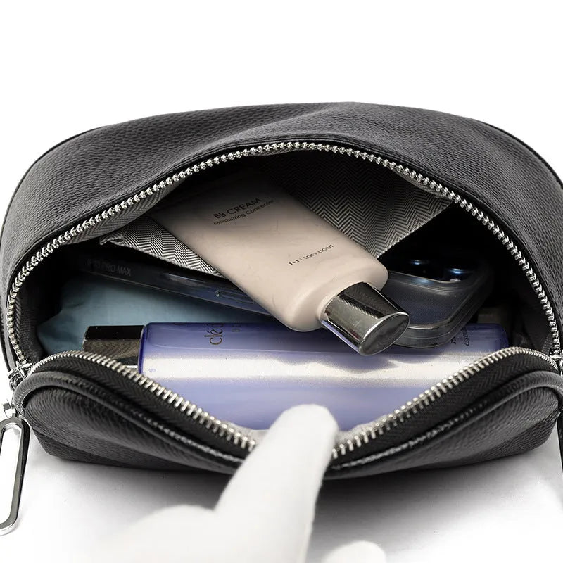 Women's saddle-shaped PU leather messenger bag in black colour with single shoulder strap and sewing line details