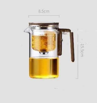 Glass teapot with wooden handle showing magnetic tea separation button and detachable inner infuser.