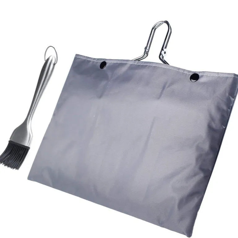 Square folding stainless steel barbecue mesh basket with a cleaning brush on a grill.