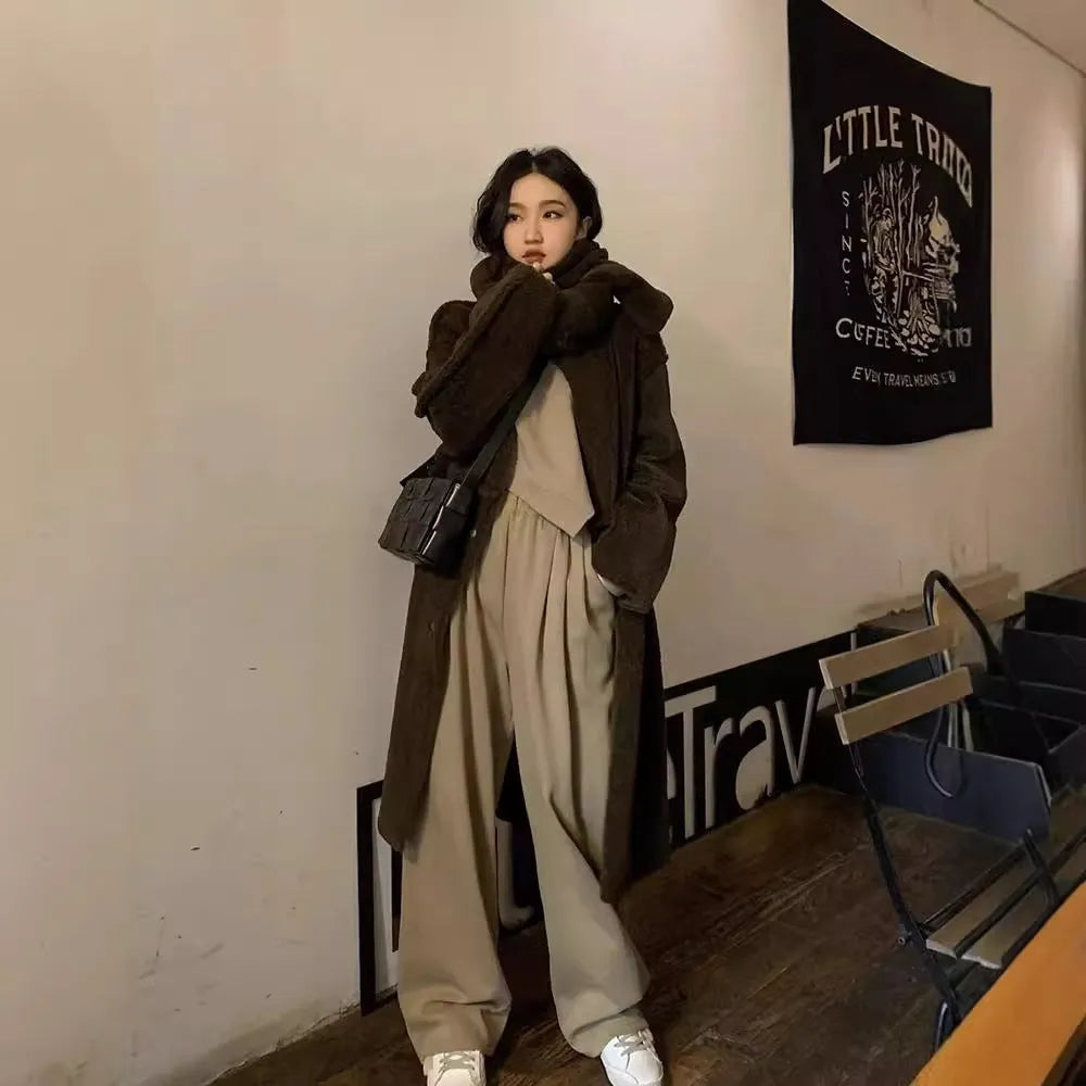 Women's khaki coloured loose-fit casual sports suit with long sleeves and trousers on a hanger.