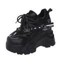 White women's low-top platform sports shoes with cross-strap and round toe on a rubber sole.