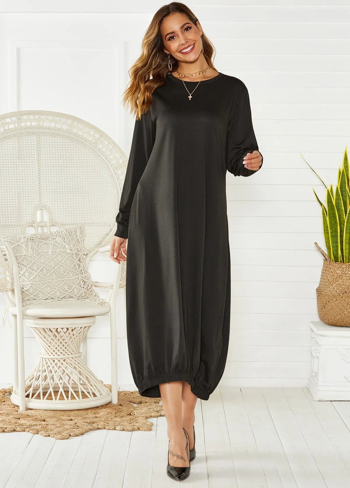Black long lantern dress with lace-up crew neck and loose knit fit, shown on a model.