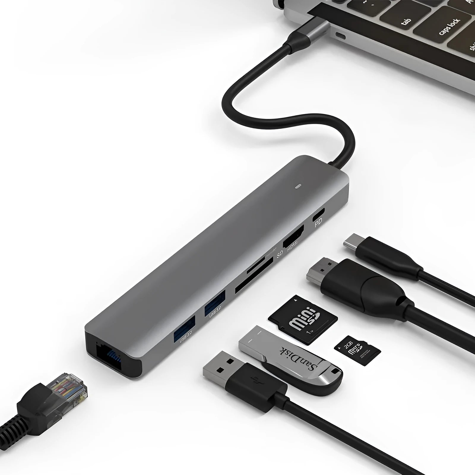 Silver aluminium 7-in-1 USB hub with SD card slot, microSD slot, USB-C PD port, and multiple USB-A ports.