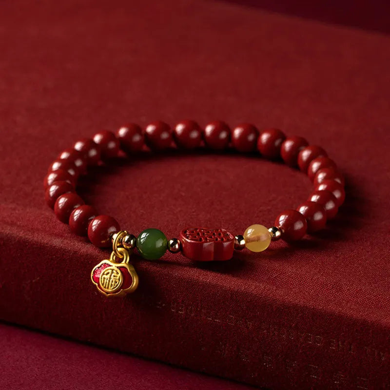 Emperor sandstone cinnabar bracelet with fu charm in 6mm and 8mm bead sizes.