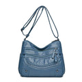 Soft PU messenger bag in horizontal square shape with multiple pockets and sewing thread detailing