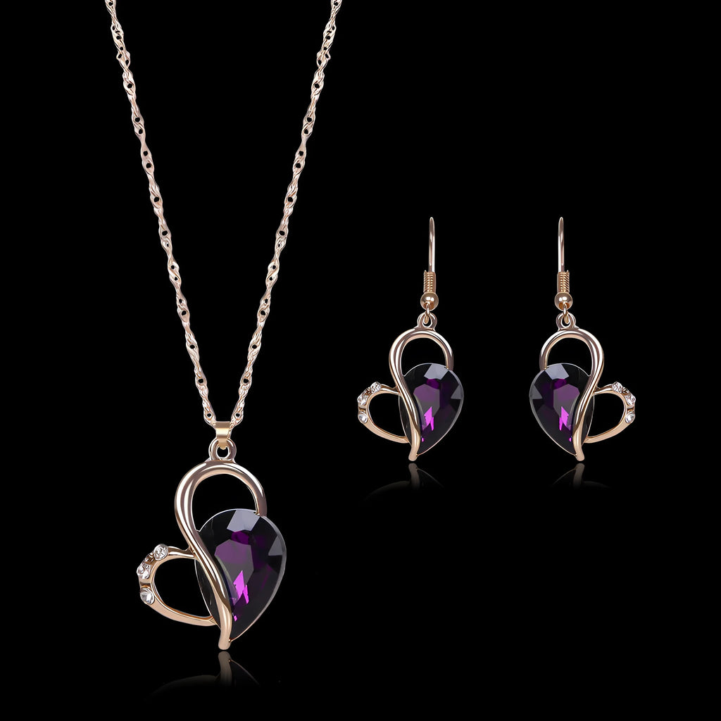 Rose gold two-piece jewellery set with heart pendant, water wave chain necklace, and earrings on display