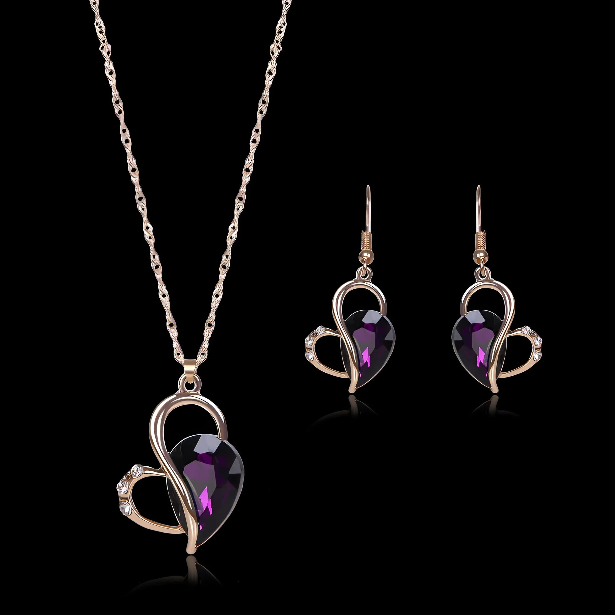 Rose gold two-piece jewellery set with heart pendant, water wave chain necklace, and earrings on display