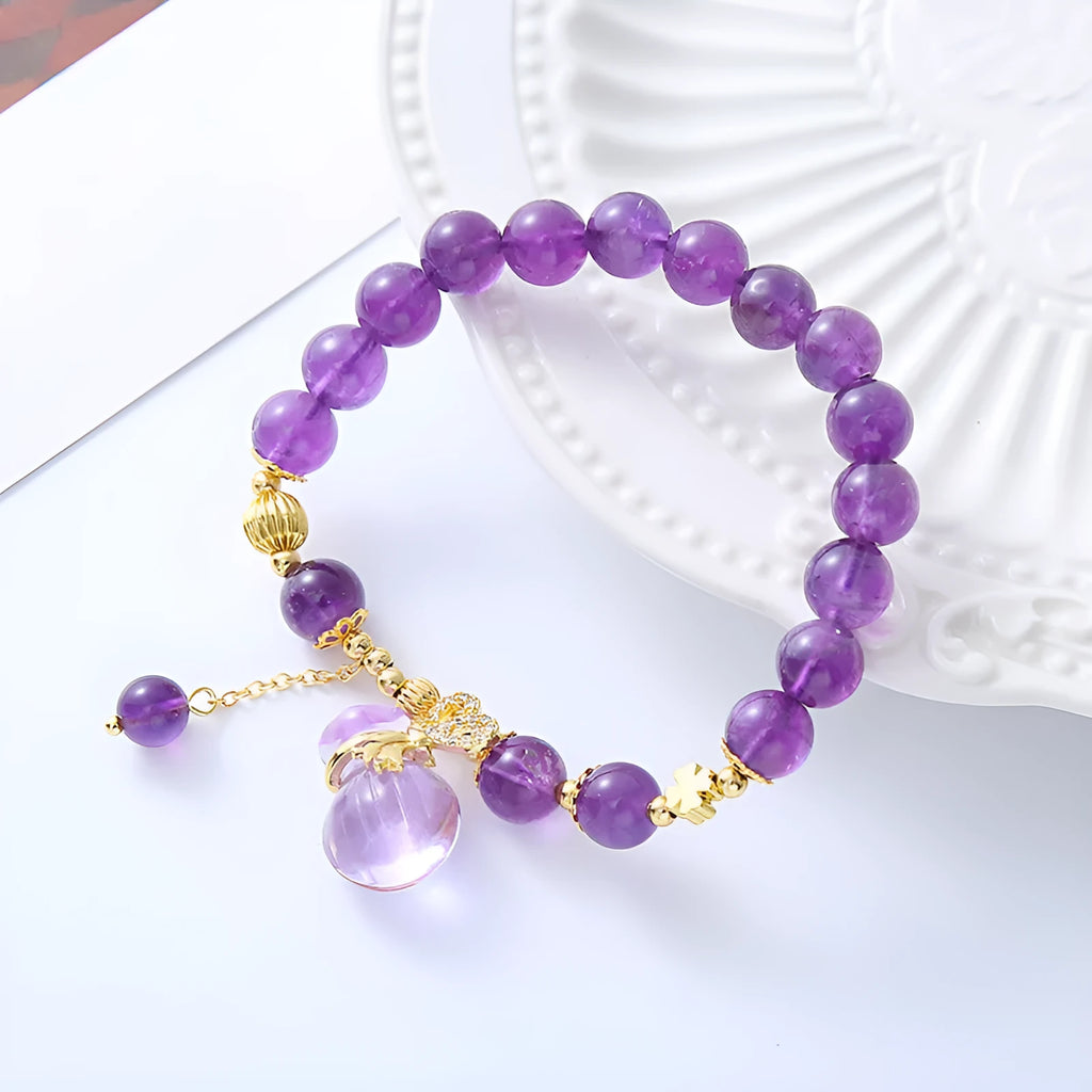 Purple amethyst bracelet with money bag pendant and peace buckle on wrist