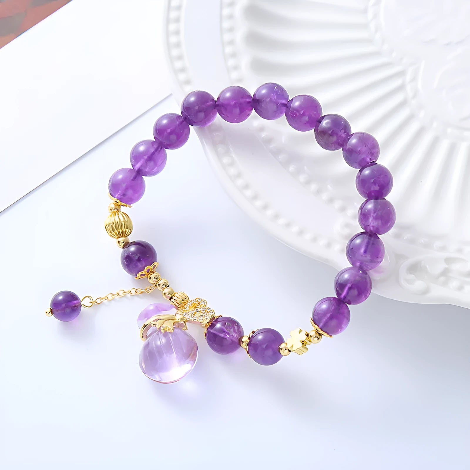 Purple amethyst bracelet with money bag pendant and peace buckle on wrist