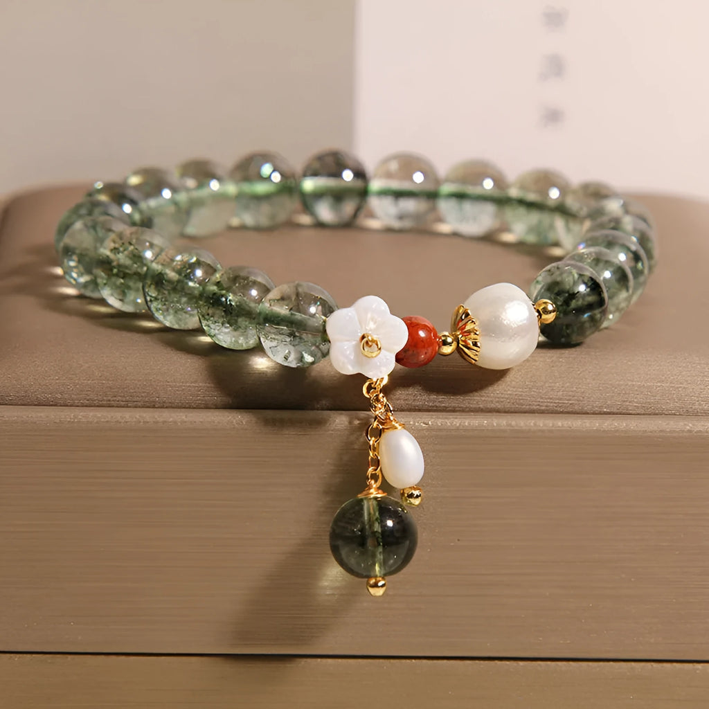 Green phantom quartz crystal bracelet with Bells of Ireland and shell flower design