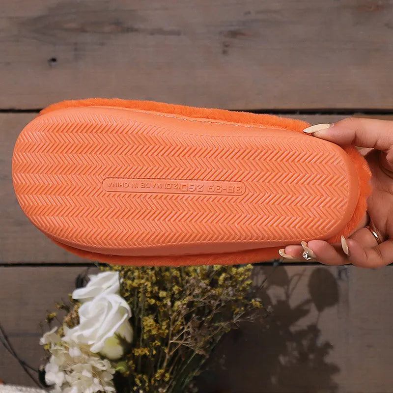Orange Halloween pumpkin-themed plush indoor slippers with a coral velvet upper and non-slip PVC sole.