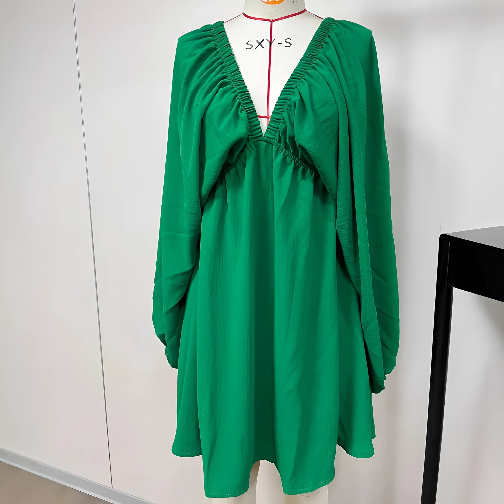 Women's apricot V-neck dress with puff sleeves and a flounced swing skirt, also available in green, black, and white.
