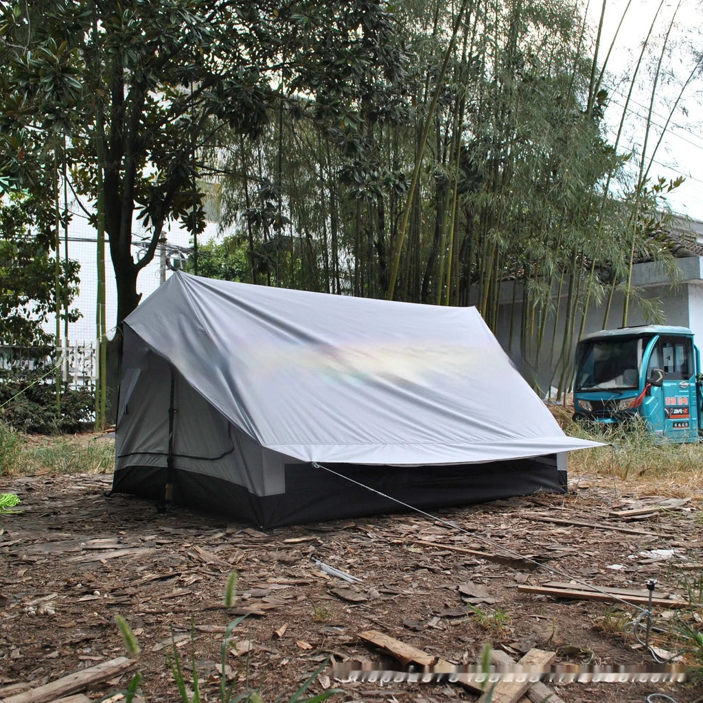 Brown A-line pole-free tent erected with hiking canes showing 2-3 person capacity and waterproof fabric construction