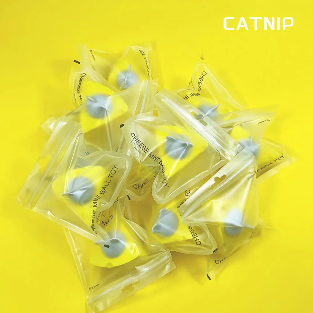 Yellow natural catnip and silvervine chew toy balls for cats on a plain background.