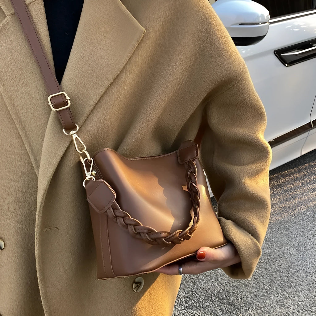 Retro khaki PU leather crossbody bucket bag with woven detail and a brown strap.