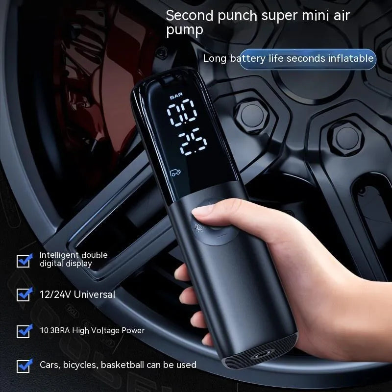 Black portable electric car air pump with tyre pressure gauge and plug connection