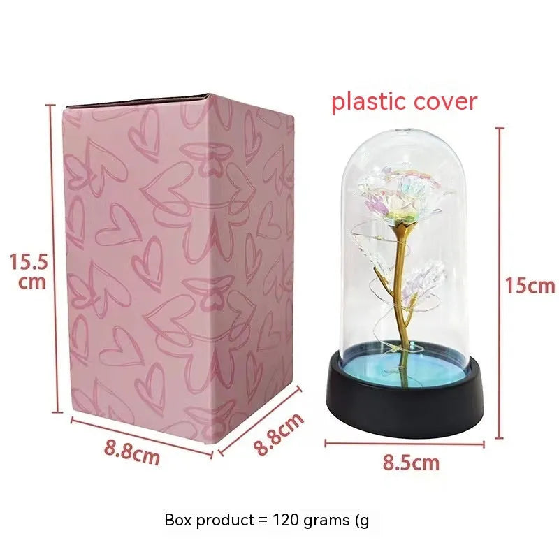 Small plastic night lamp with glass-style cover and decorative flowers, showing coloured LED light options.