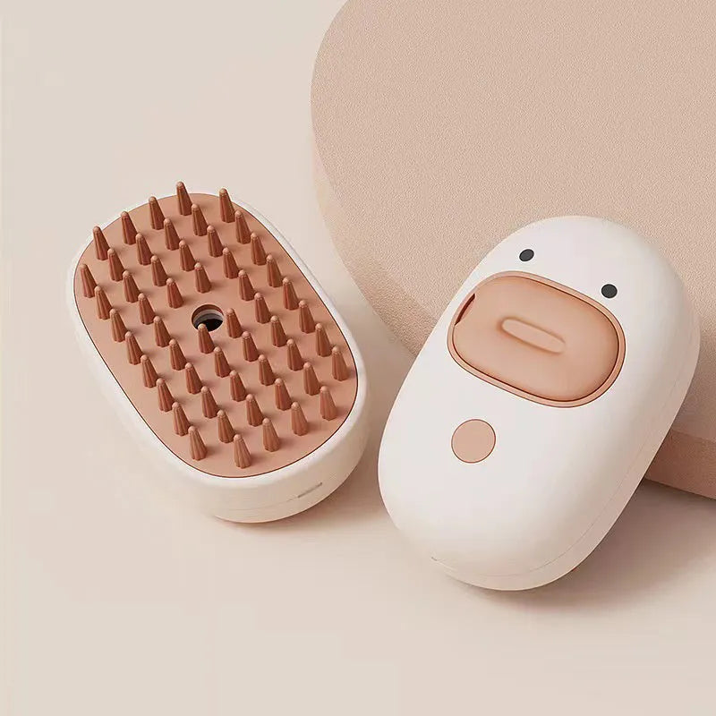 White rechargeable silicone steam brush for grooming dogs and cats on a table.