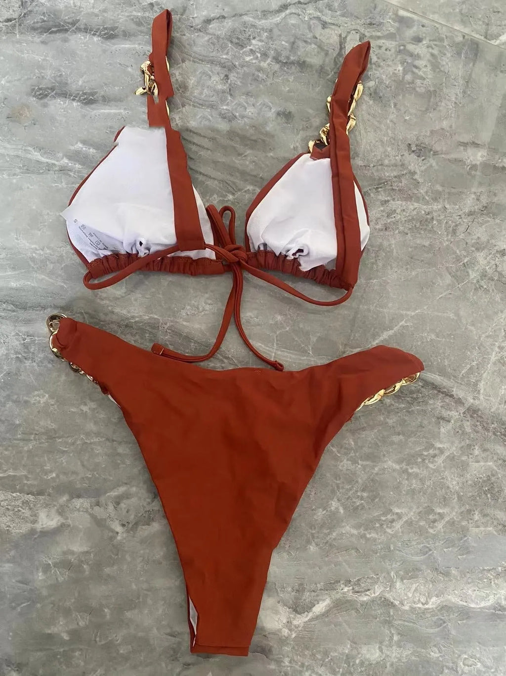 Brown women's tube top ring tether push up bikini swimsuit laid flat.