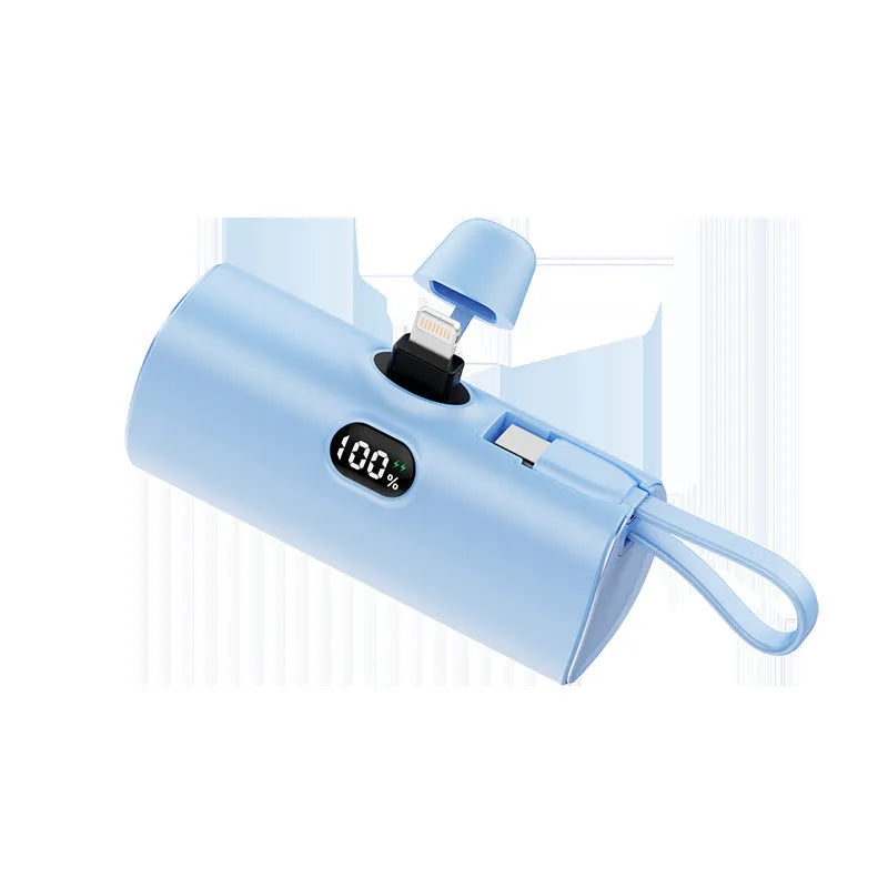 Compact capsule‑shaped digital display power bank with integrated plug, shown in multiple colours.