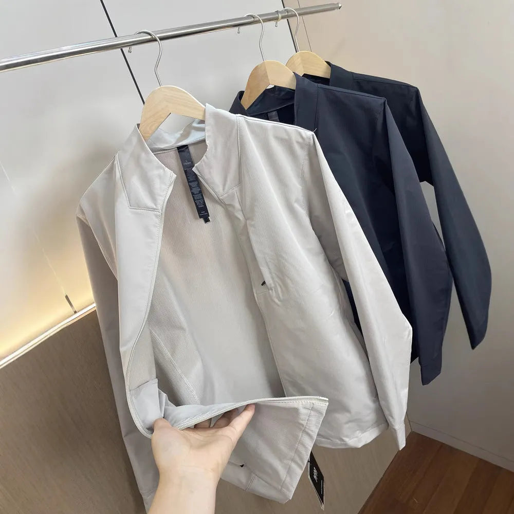 Men's beige stand collar casual sports jacket with long sleeves on a hanger.