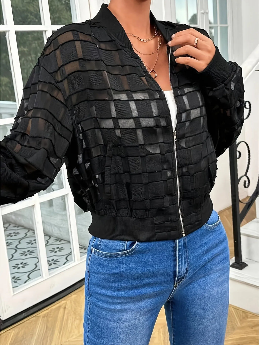 Black women's casual jacket with geometric pattern and semi-transparent thread zipper detail.