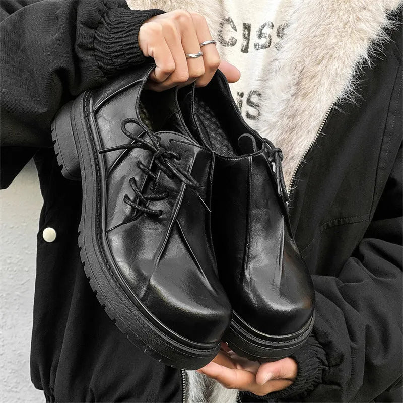 Black platform shoes with round toe and low top design for height enhancement