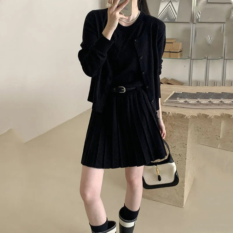 Grey art retro knitted two-piece set for women, showing a vest skirt and long-sleeved cardigan with a belt.