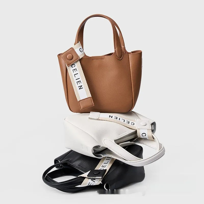 Brown cattlehide leather cross body bucket bag with square vertical design and slit pocket