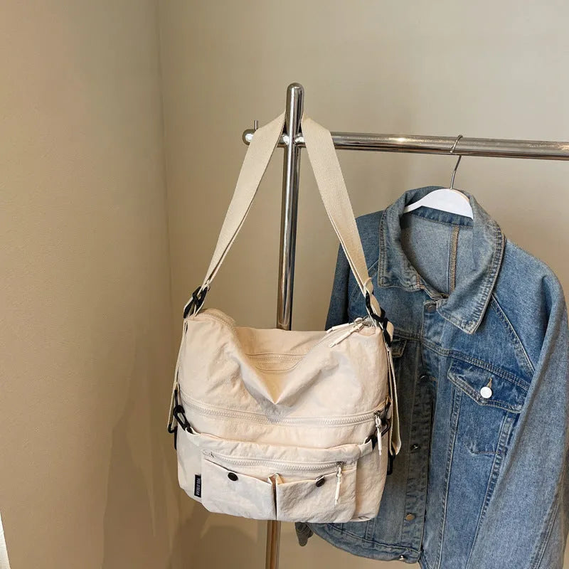 Women's nylon crossbody bag in square vertical shape with double shoulder straps and organised interior compartments