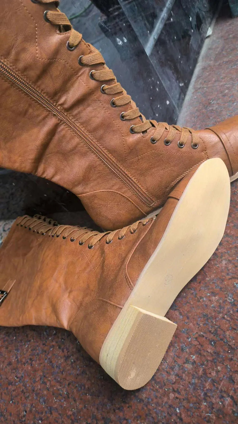 Women's black artificial PU leather knight boots with a cross-strap design, shown from the side.
