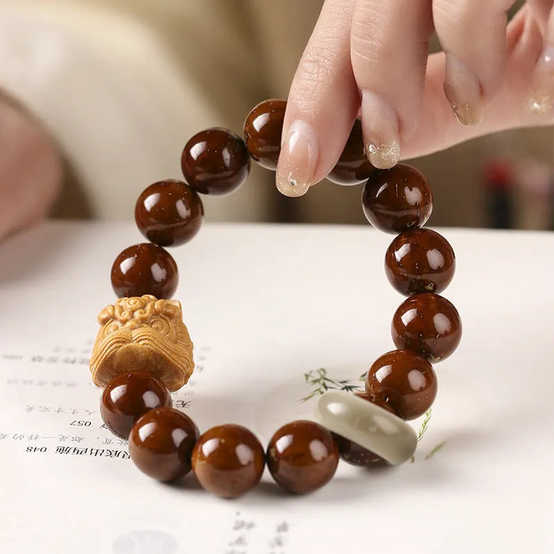 Hand-woven round bead bracelet in ivory nut lion style with 13mm beads