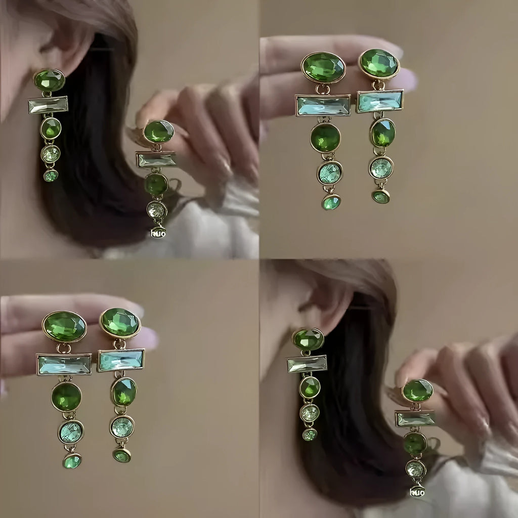 A pair of green gradient geometric drop earrings with inlaid zircon stones and a dangling tassel detail.