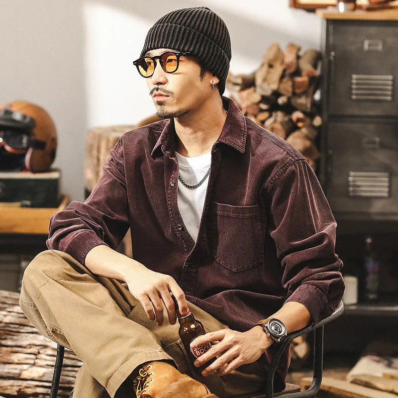Men's loose-fit corduroy shirt jacket in red or black, showing long sleeves and button front.