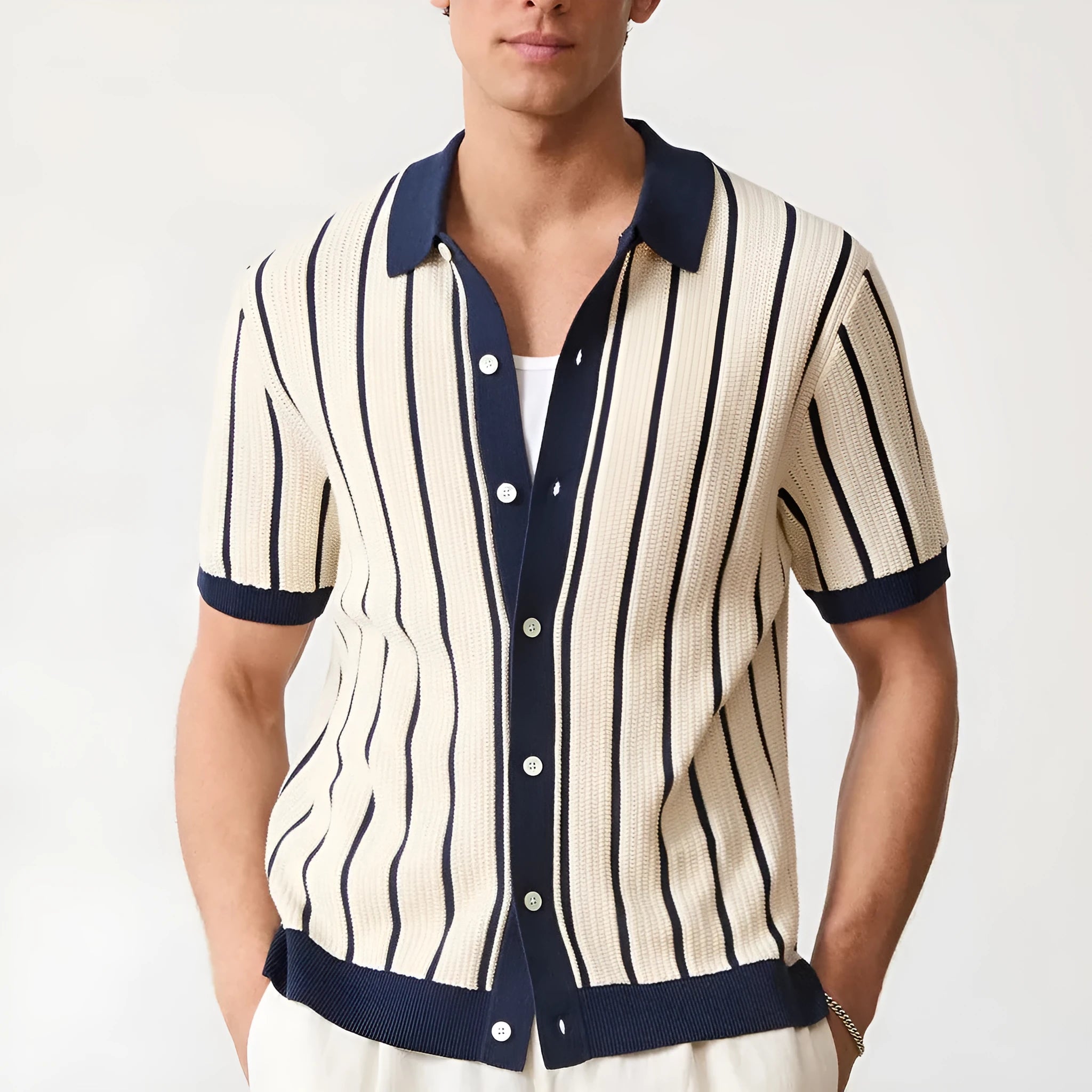 Men's white short sleeve knitted top with lapel collar and asymmetric design.