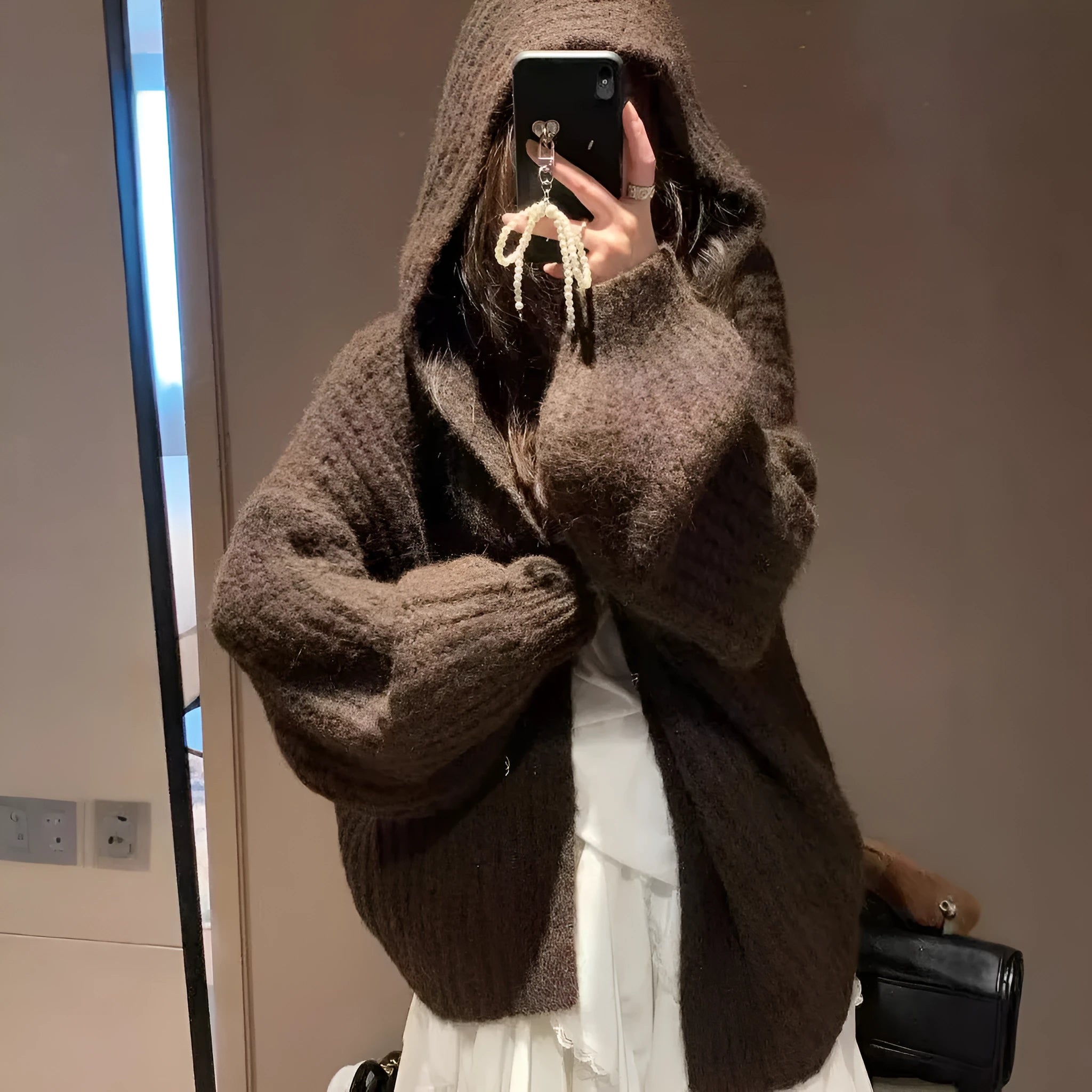Woman wearing a dark grey retro knit Maillard pattern hooded cardigan