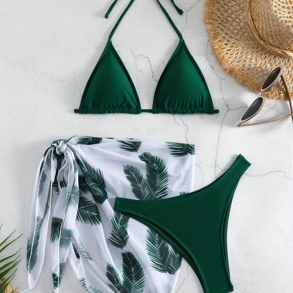Orange three-piece bikini swimsuit set with a matching printed gauze skirt laid flat.