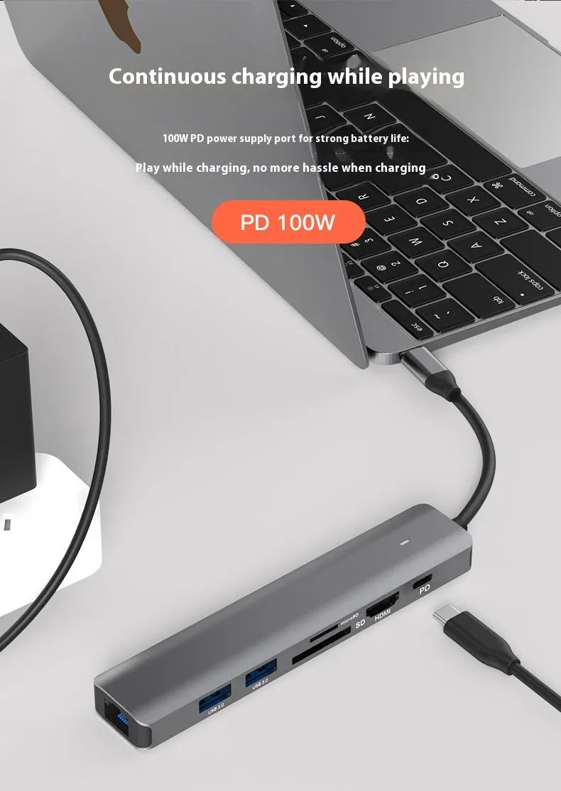 Silver aluminium 7-in-1 USB hub with SD card slot, microSD slot, USB-C PD port, and multiple USB-A ports.