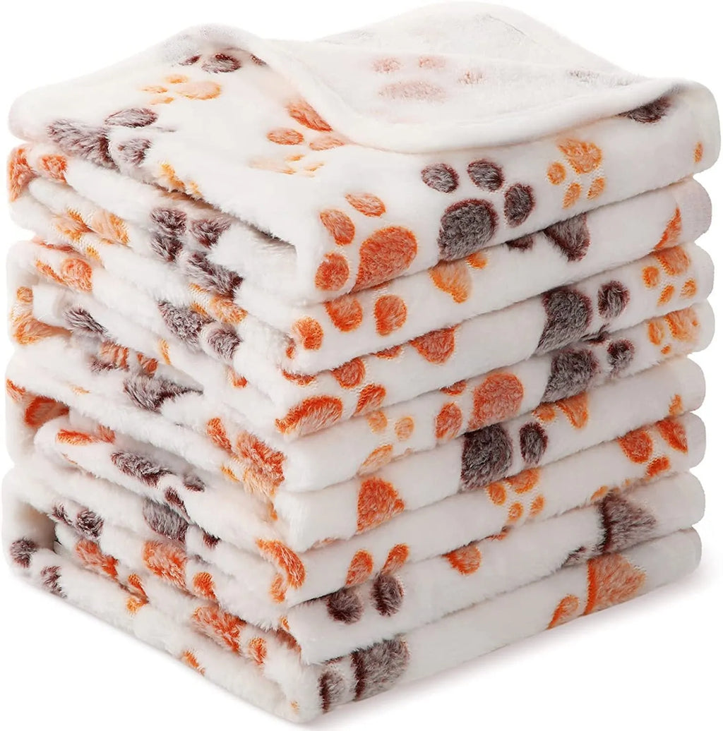 Coral fleece dog blanket with dog's paw pattern in selected colour and size