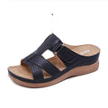 Women's black wedge sandals with a peep toe and Velcro fastening strap.