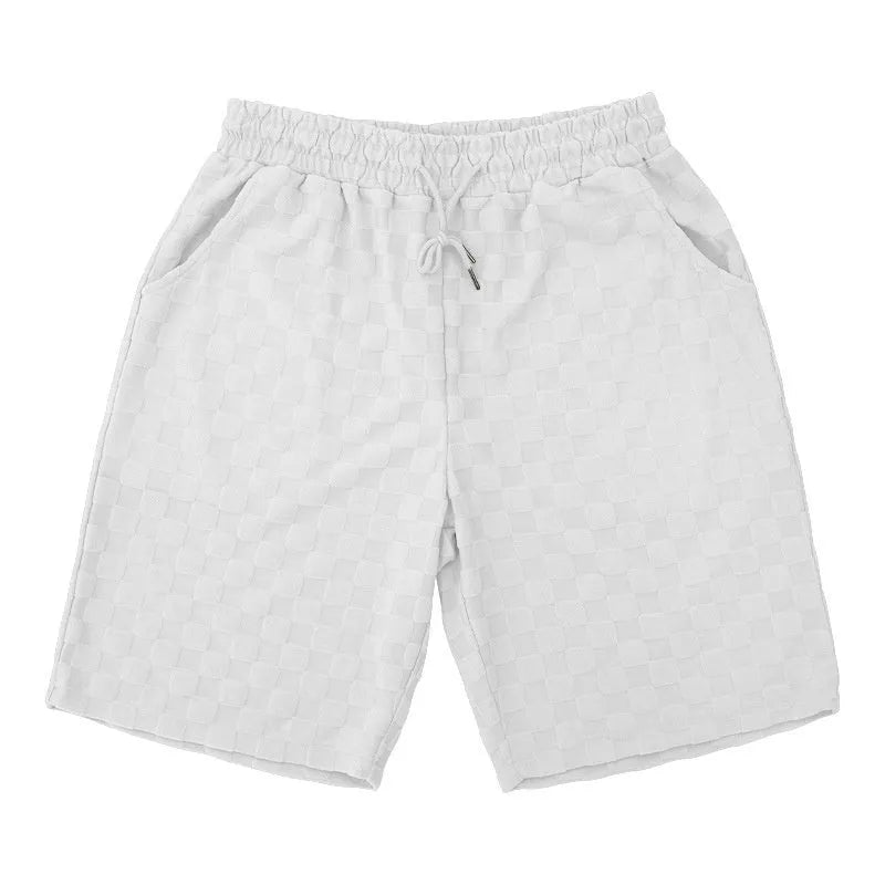 Men's black and white checkerboard plaid loose sports shorts with an elastic waistband.