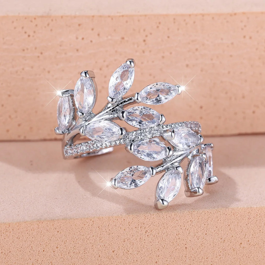 Adjustable copper leaf-shaped ring with a Horse Eye Zircon stone, shown in a rose gold finish.