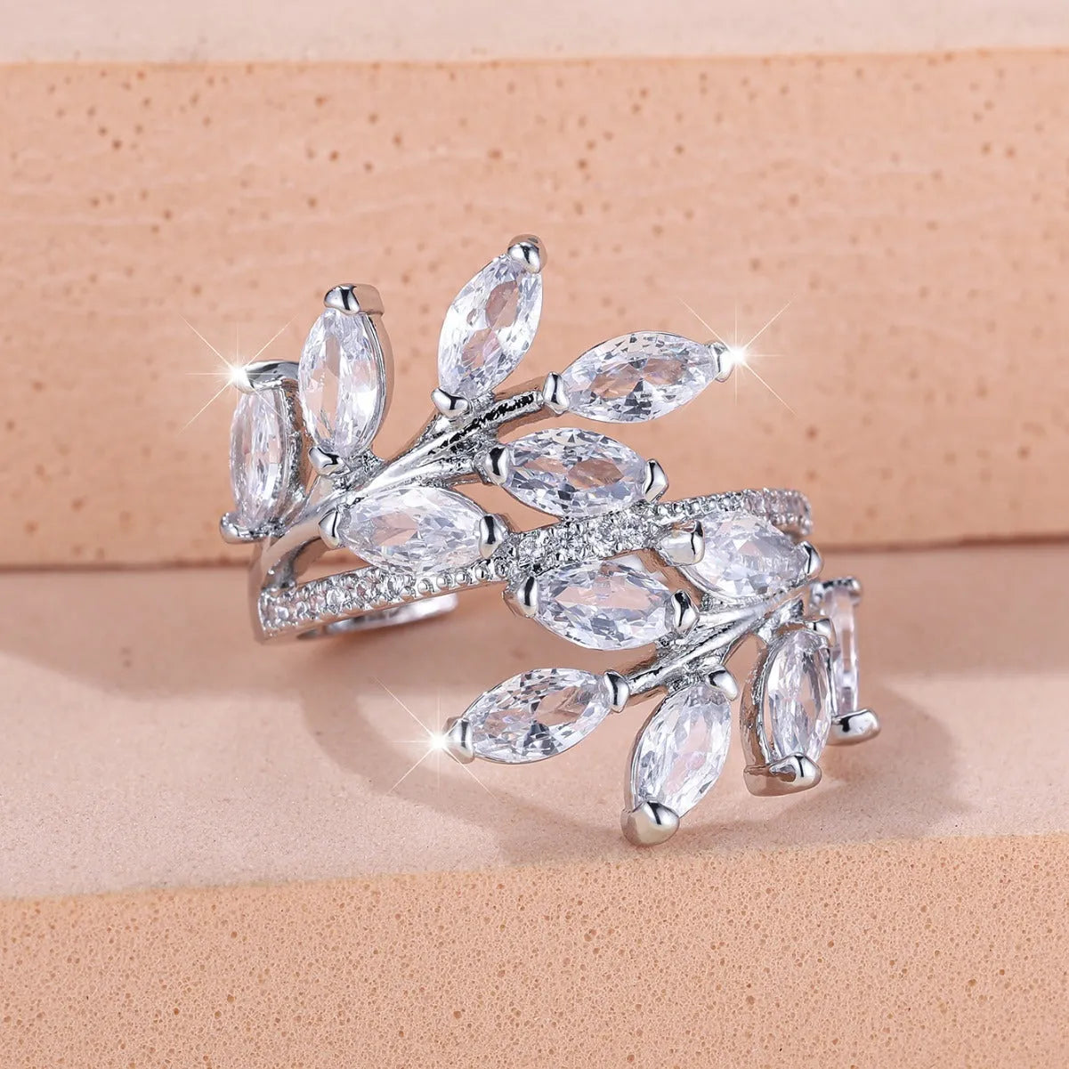 Adjustable copper leaf-shaped ring with a Horse Eye Zircon stone, shown in a rose gold finish.