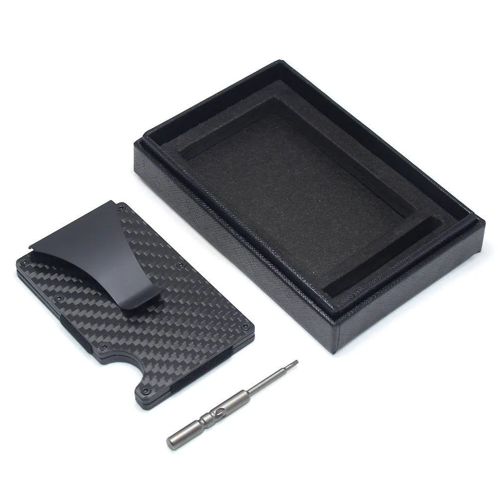 Slim black carbon fibre card holder wallet with geometric design on a desk.