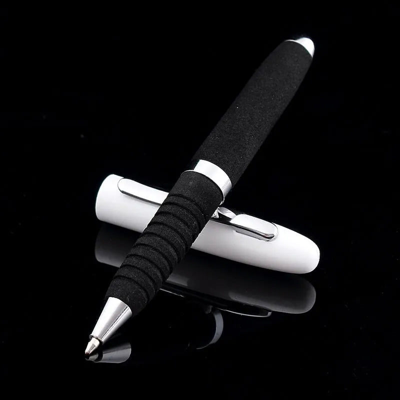 Close-up of a silver EVA metal cap mini ballpoint pen with a 1.0 mm bullet tip, shown with a bright black refill.