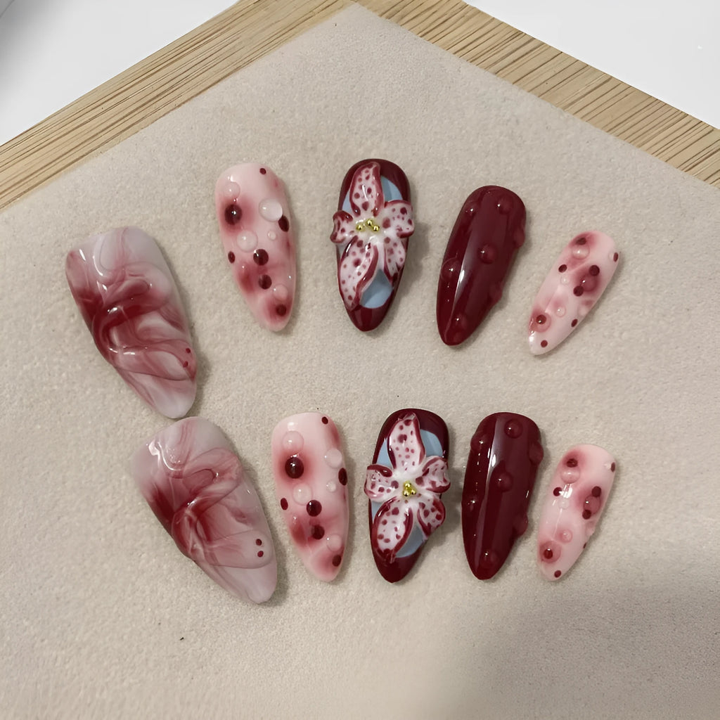 Hand-painted three-dimensional carved almond manicure nails with floral patterns in medium length