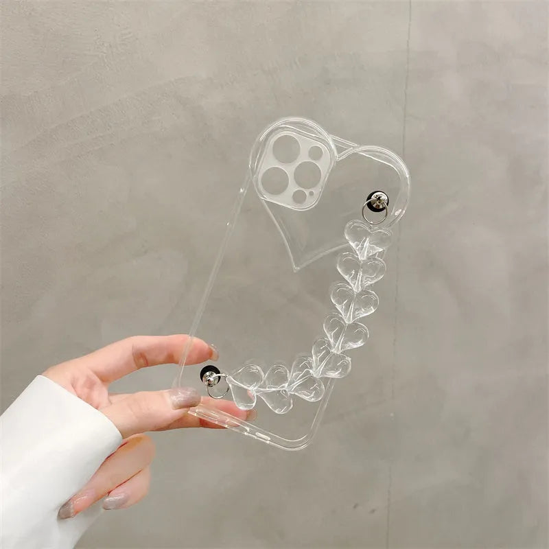 Transparent soft TPU iPhone case with a built-in clear love heart charm and chain.