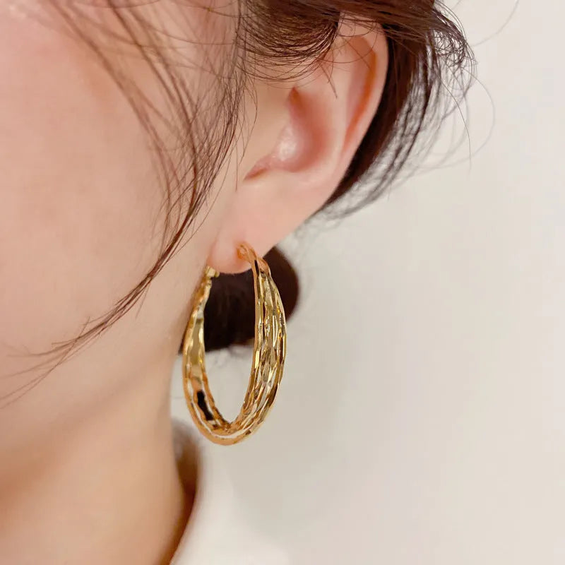 Simple metal twisted earrings for women, copper geometric round shape, available in gold or silver finish
